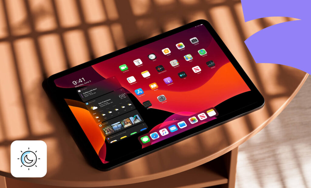 Tablet on a round table displaying a dark mode home screen with app icons and widget