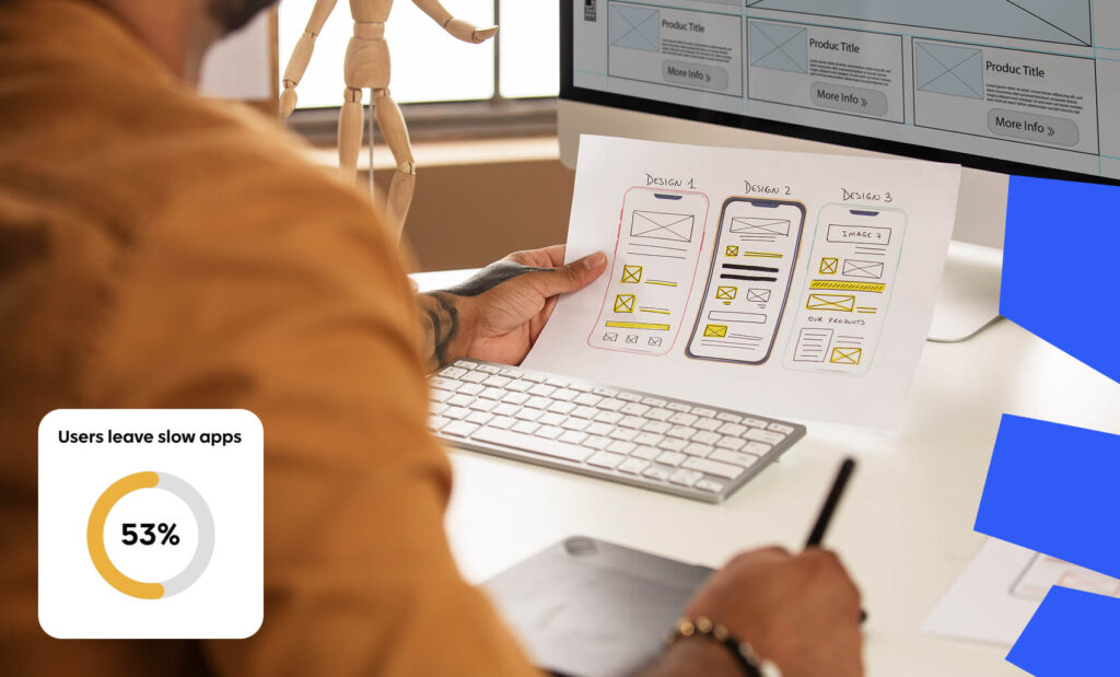 A designer with tattooed arms holds a paper showing three mobile app wireframes