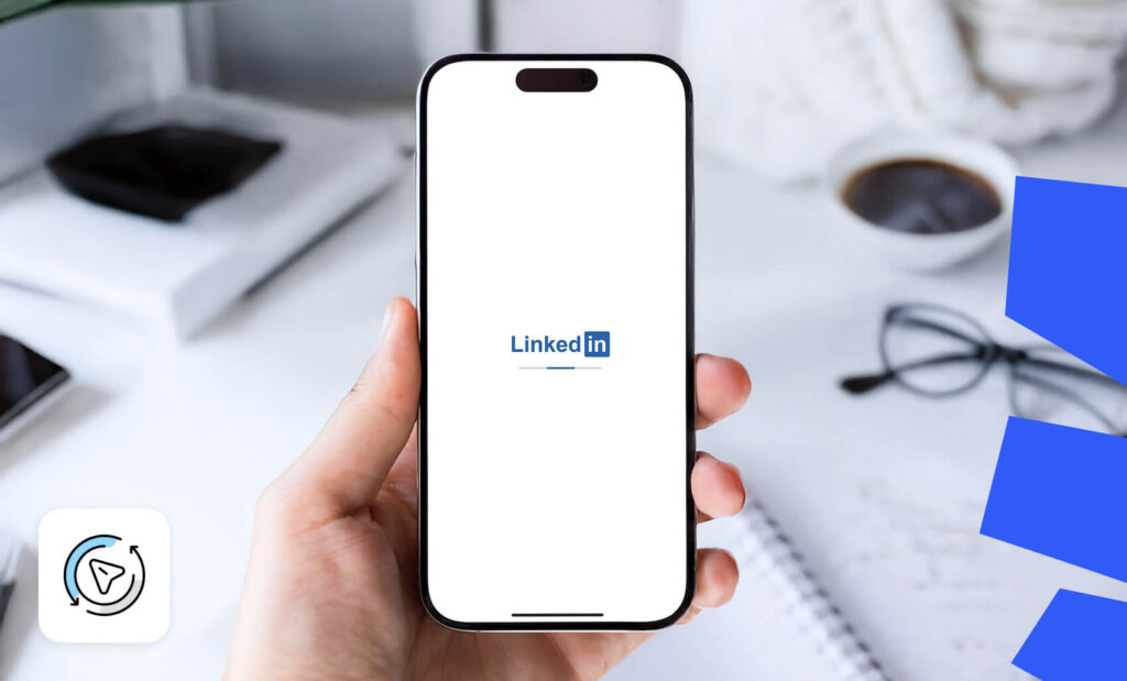 Hand holding a smartphone displaying the LinkedIn logo on a white screen, suggesting a loading state or micro-interaction