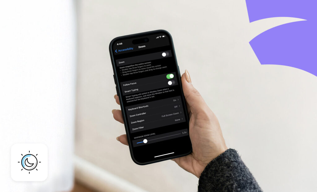 Person holding a smartphone showing accessibility zoom settings in dark mode