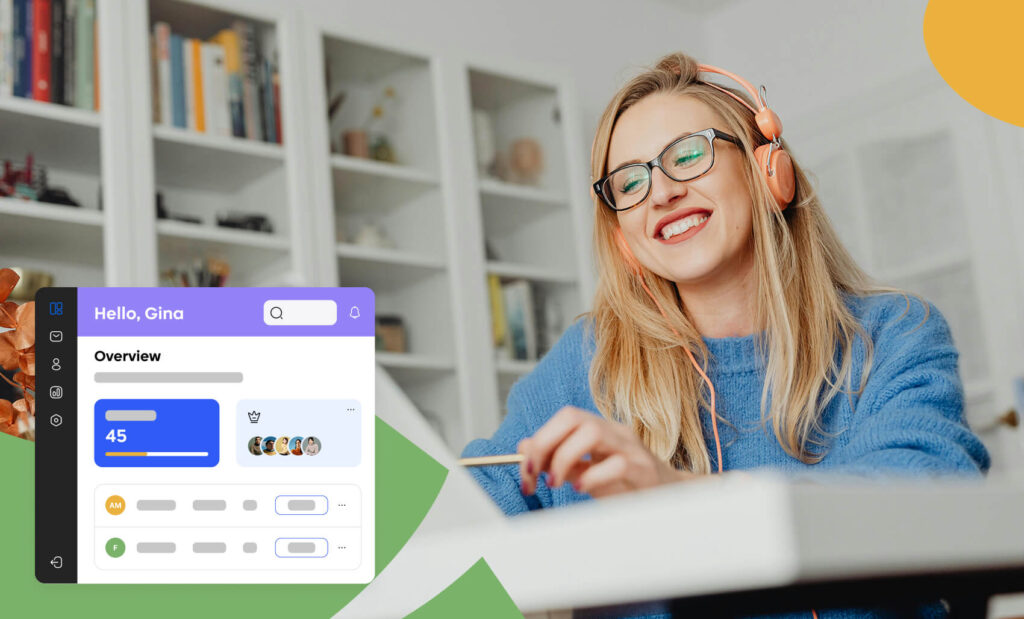 A woman wearing headphones and smiling while working at a desk